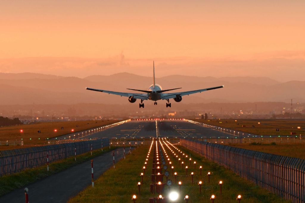 Aterrizaje de un avión bajo el sol del atardecer