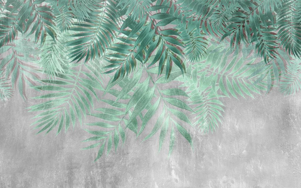 Hojas de palmera verdes con muro de hormigón gris