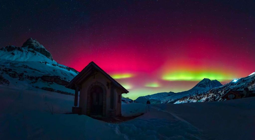 Aurora boreal sobre monta√±as nevadas